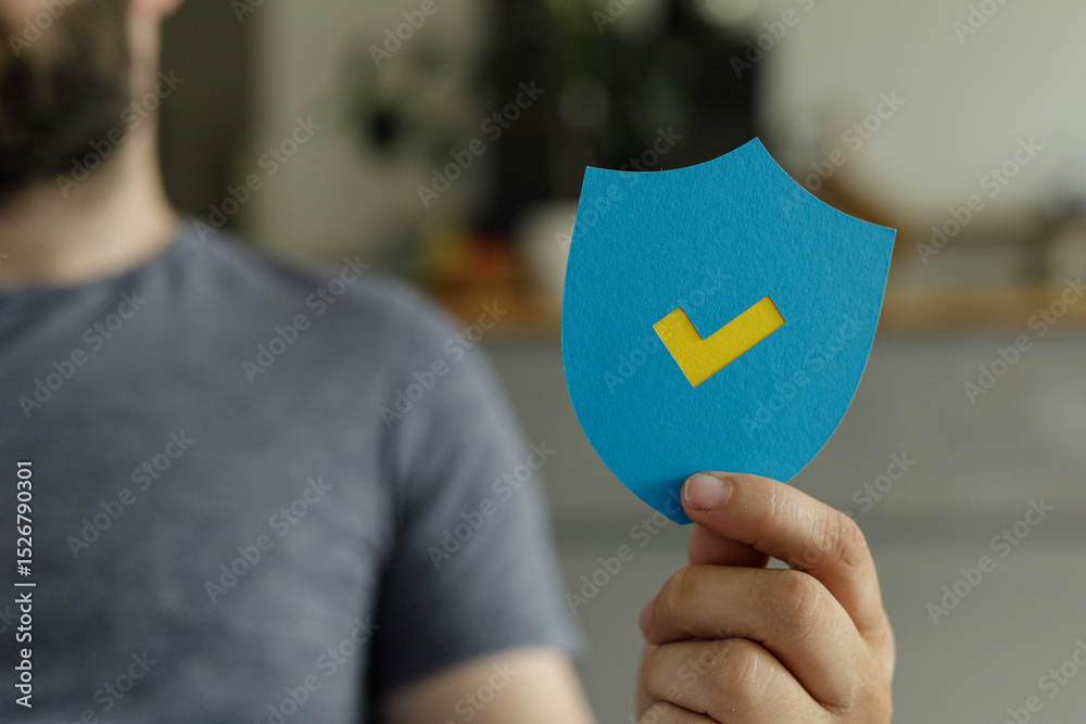Poster image of a person holding a blue shield with a yellow checkmark, representing security and approval.