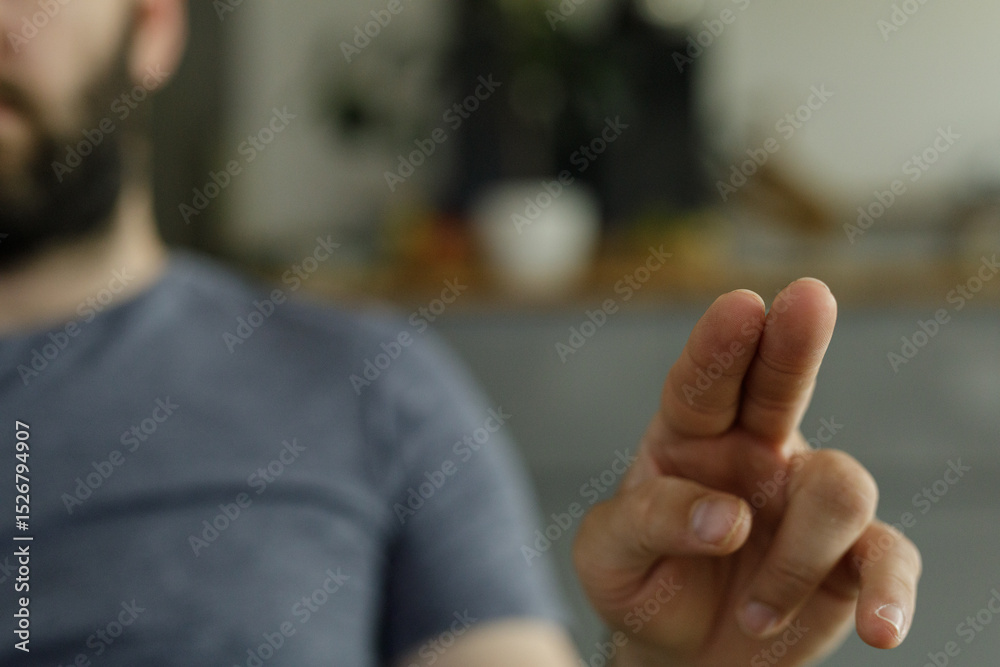 Poster close-up of a man's hand using two fingers on a touchscreen.