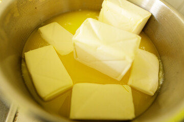 Close-up of butter cubes melting in a pan.  Perfect for baking or cooking recipes.