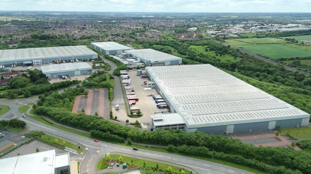 Aerial view drone flight above business park warehouse district factory units data centre quantum computing on a sunny day in the UK logistics and transport of goods economics. 