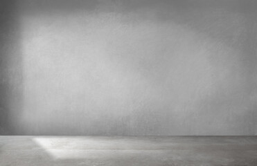 A dull gray room featuring a concrete floor accompanied by a gray wall