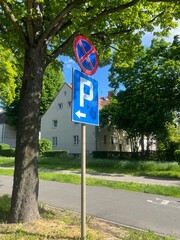 No Parking and One Way Signpost on a City Street