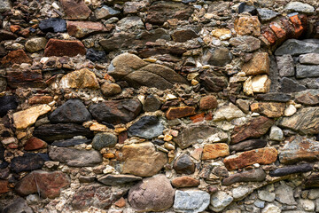 Medieval stone wall build between the 16-17 century close up shot for background.