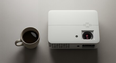 Obraz premium Portable projector and coffee cup on light surface