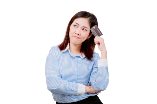 A woman in a blue striped shirt holds a credit card to her temple with a thoughtful and uncertain expression.