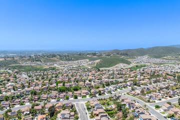Aerial view of San Marcos neighborhood with houses and street during sunny day, South California, USA.