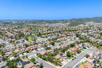 Aerial view of San Marcos neighborhood with houses and street during sunny day, South California, USA.