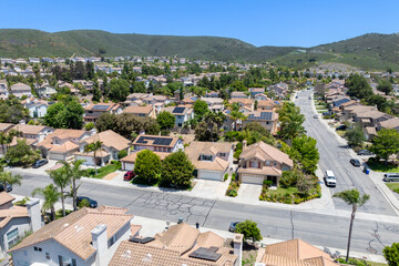 Aerial view of San Marcos neighborhood with houses and street during sunny day, South California, USA.