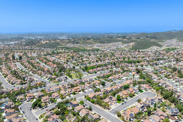 Aerial view of San Marcos neighborhood with houses and street during sunny day, South California, USA.