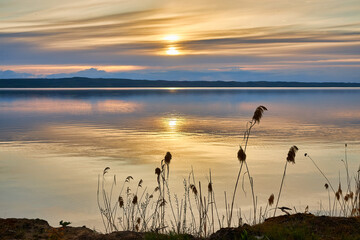 Serene Lake Sunrise with Golden Light Reflection