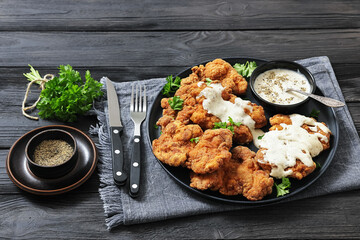Deep fried Southern chicken thighs with milk gravy