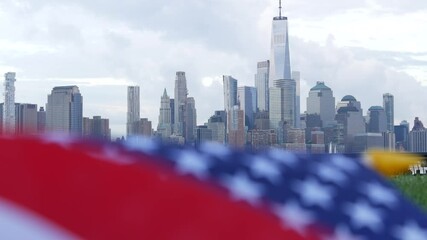 New York City waterfront skyline, Manhattan Downtown World Trade Center skyscraper. Cityscape from New Jersey, United States. American flag 11 September, USA. Independence and Remembrance symbol. Wind