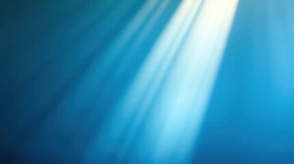 Blue background with blurred rays of light shining in from the top right corner