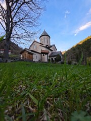Timotesubani Monastery rising above green grass in the afternoon sun
