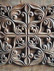Intricate wood carving forming floral pattern on wooden door