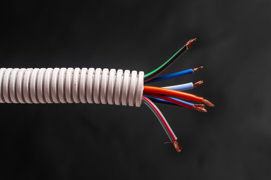 A bundle of electrical wires in a plastic corrugated tube.