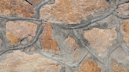 Close-up of textured stone wall with irregular shapes