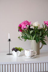 Beautiful and Elegant Floral Arrangement Featuring a Charming Teacup and Fresh Fruit on Table