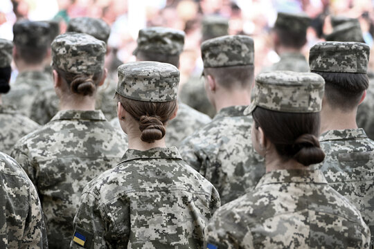 Woman soldier. Woman in army. Ukrainian flag on military uniform. Ukraine troops.