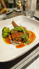 American cuisine. Large juicy grilled steak on a tomahawk bone. Beef steak with peas