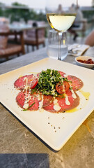 Beef carpaccio with parmesan cheese and rocket leaves