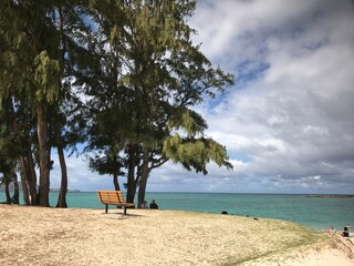 Beach Scene with Lounge Chair and Calm Ocean