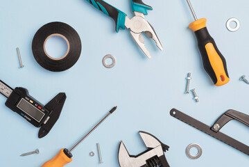 Worker tools on blue concrete background with copy space