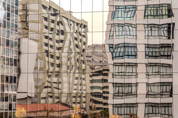 Reflection of buildings in windows of another building with a cubist painting effect