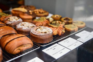 Golden flaky croissants  and  pastry sweets with toppings displayed in a  frech  bakery  at Monaco
Delicious croissants on the store showcase.

