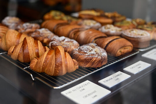 Golden flaky croissants  and  pastry sweets with toppings displayed in a  frech  bakery  at Monaco
Delicious croissants on the store showcase.
