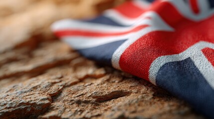 Union Jack flag rests on textured stone surface. British patriotism, national identity, United Kingdom pride, historical symbol.