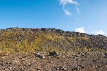 Breathtaking Icelandic landscape with lava rocks and iconic moss under a sunny sky on the...