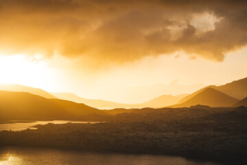 Golden sunset over the lava fields of Berserkjahraun near Selvallavatn lake in Stykkisholmsbar district, Iceland. A surreal volcanic landscape bathed in warm light