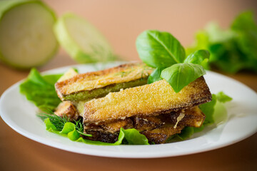 Fried zucchini slices with salad greens