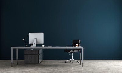 A desk with a computer and chair in an office with blue wall