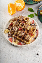 Chocolate Drizzled Waffles with Strawberries and Bananas