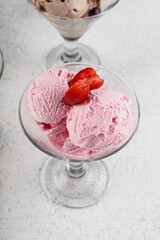 Strawberry ice cream scoop in glass cup
