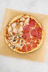 Pizza with pepperoni, mushrooms and chicken topping