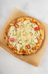 Pizza with salad greens, cherry tomatoes and cheese