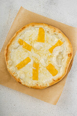 Mozzarella pizza with golden cheddar topping on crust