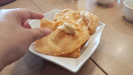 Kerupuk pangsit  goreng or Crispy fried wontons on a plate at restaurant
