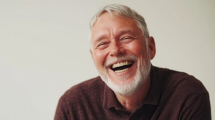 Obraz premium Studio portrait of mature man laughing in studio on white background. Generative AI.