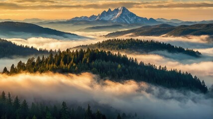 Fototapeta premium Mountainous landscape bathed in golden sunrise light, shrouded in mist