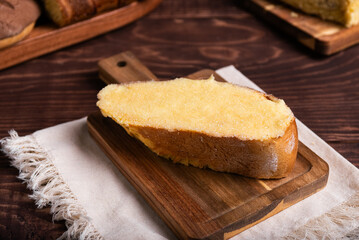 A delicious slice of buttered sweet bread, browned and generously coated with sugar