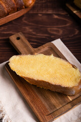A delicious slice of buttered sweet bread, browned and generously coated with sugar
