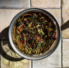 Herbal aromatic tea. Dry tea leaves in a jar - calendula, lingonberry, mint.