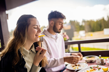 ouple enjoying meal with mountain view
