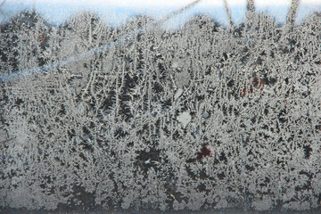 Patterns on the window in winter. Winter drawing on the window. Natural pattern