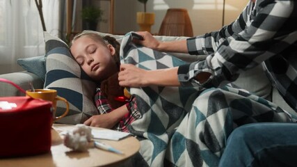 Caucasian family at home ill sick sleeping kid girl daughter mother woman mom cover child with blanket touching forehead checking temperature fever childcare health problem medicine symptom pandemic