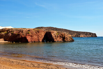 beach in Mazarrón, Spain, with red rocks the beach is characterized by fine golden sand and crystal clear water, town located in the region of Murcia, in the south-east of Spain